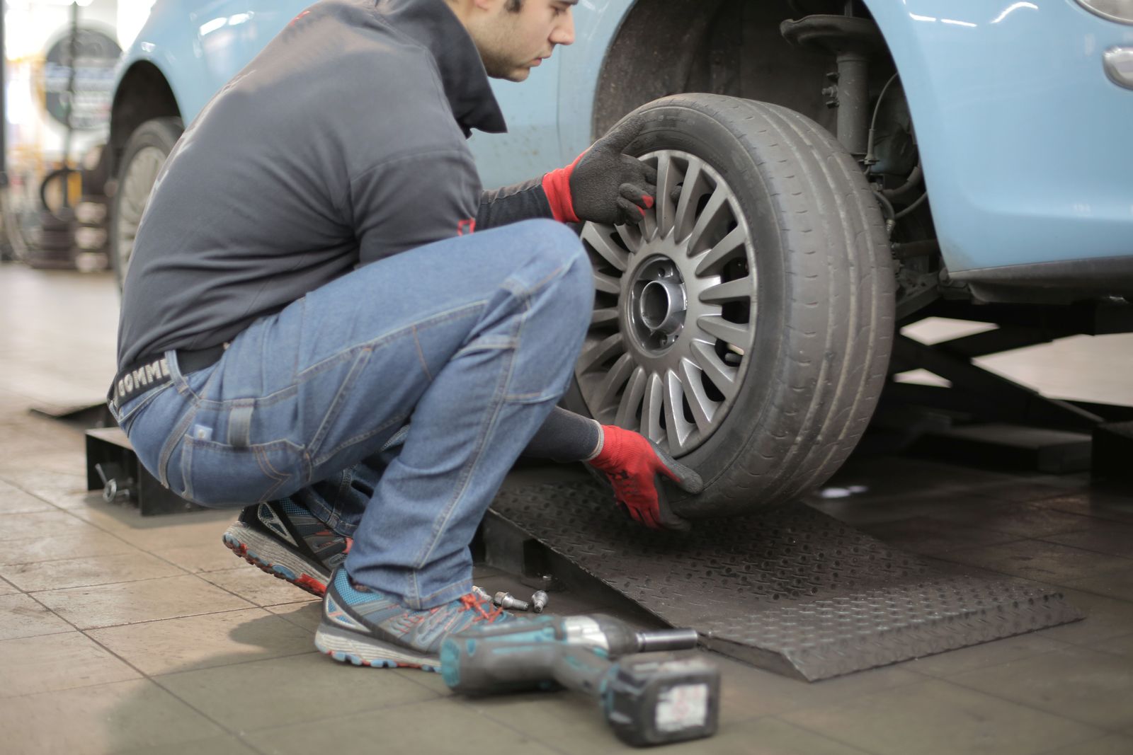 Alloy wheel being fitted during a balancing and tyre job